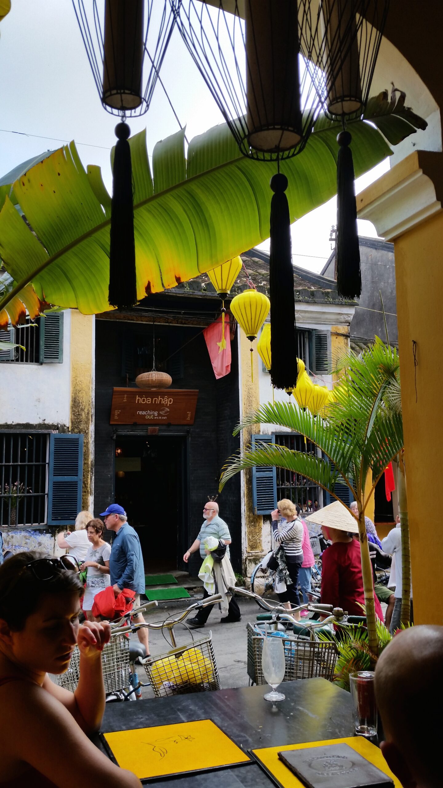 Street view with people and hanging lanterns.