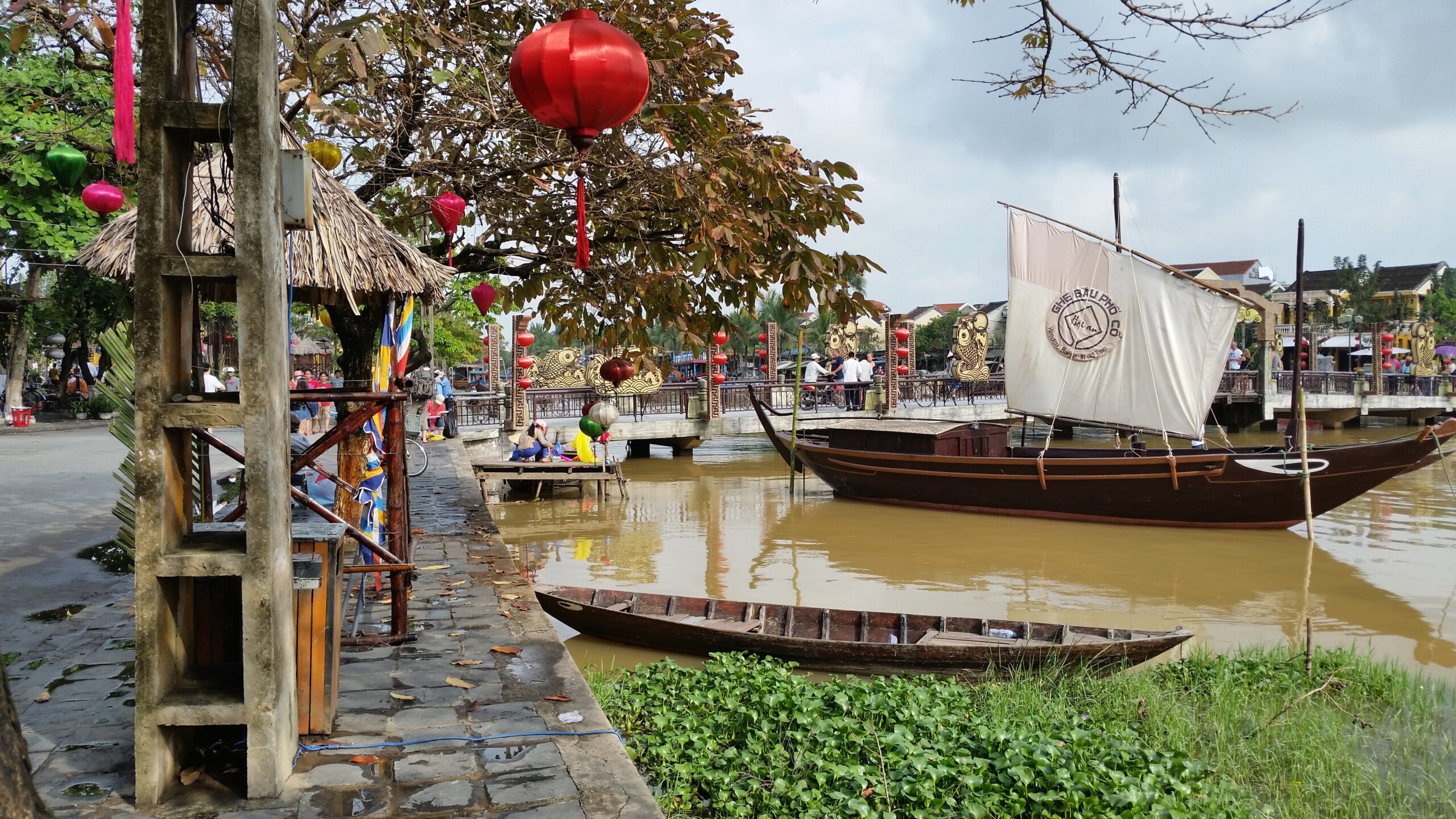 Boats on river with red lanterns hanging.