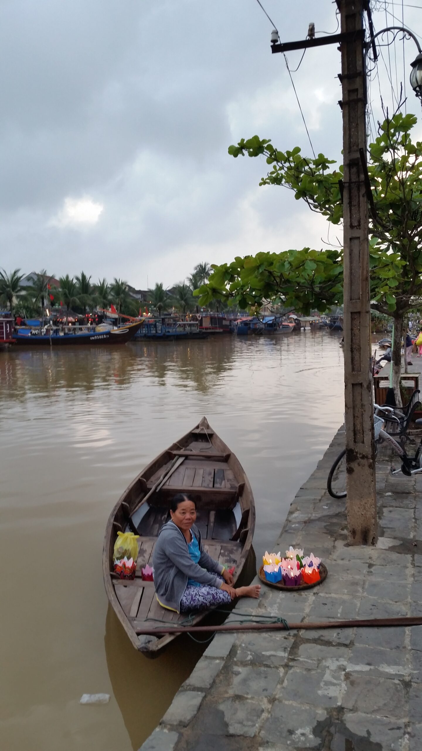 Woman selling goods from a boat.