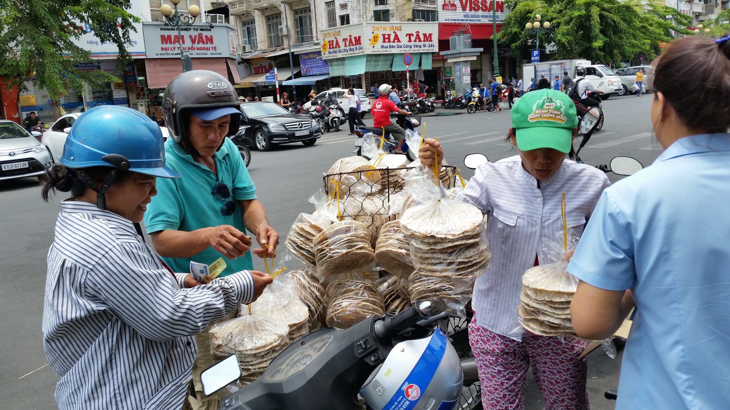 Street vendors selling rice paper to customers.