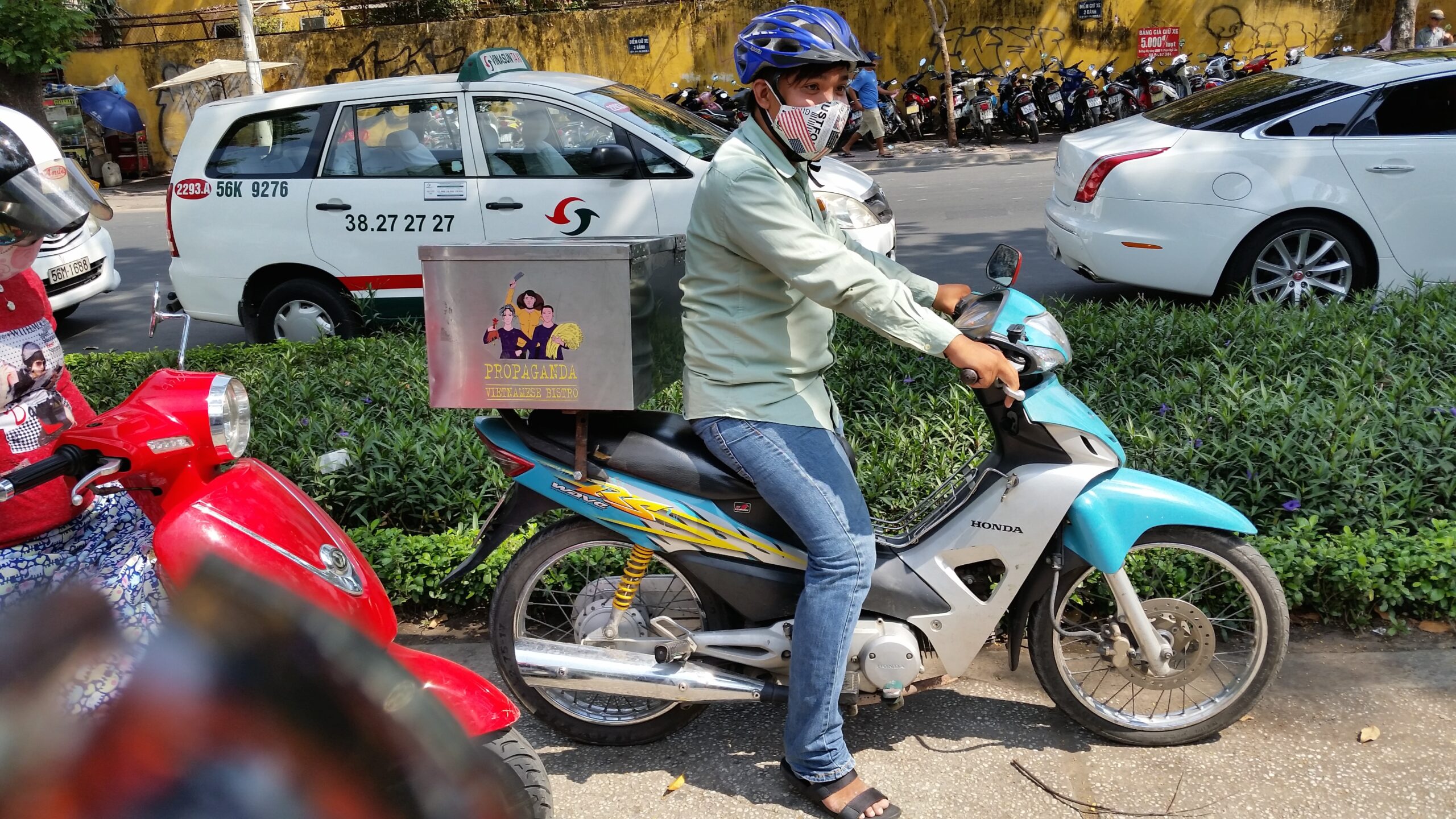 Man on motorbike with helmet and mask.