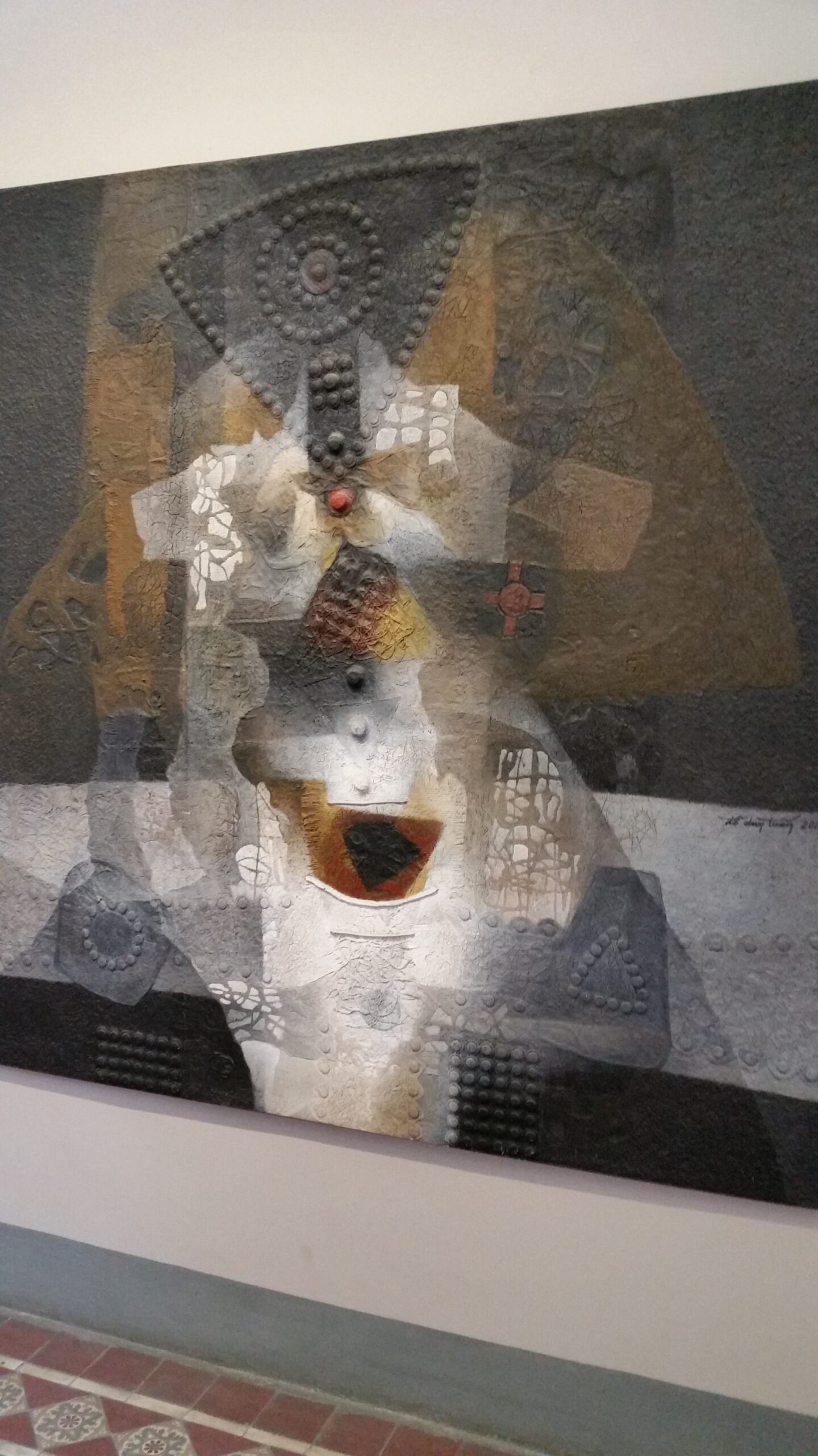 Abstract mixed media artwork with geometric patterns.