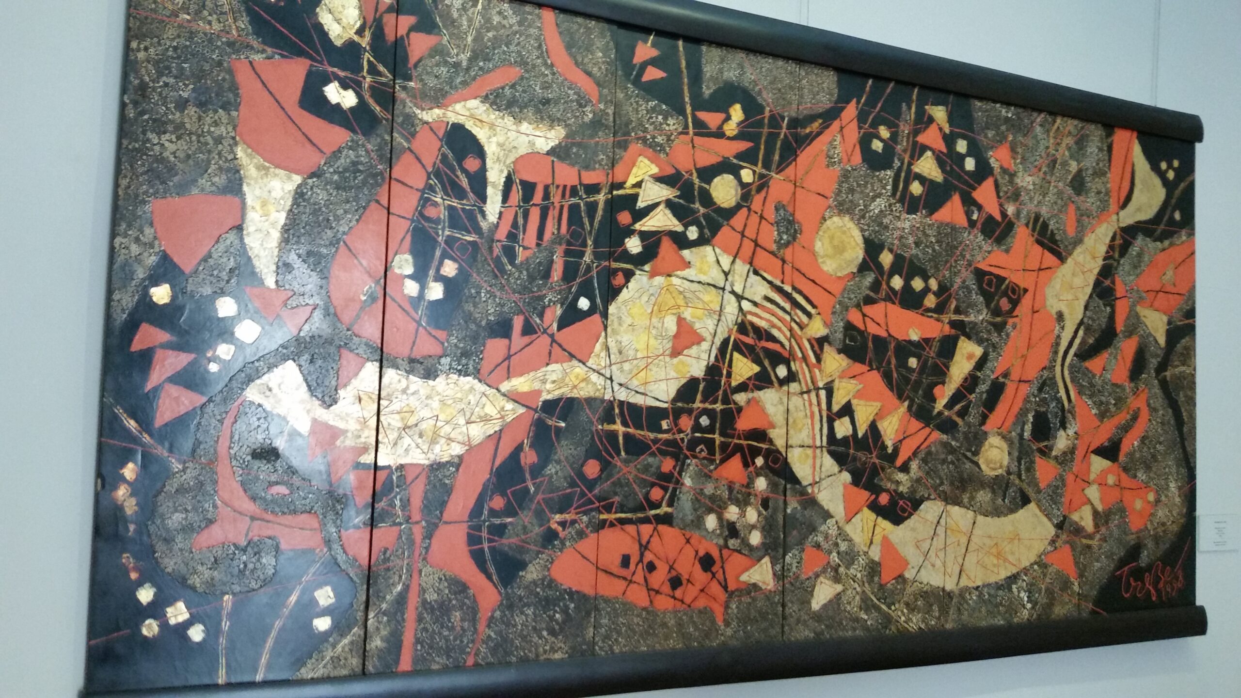 Abstract painting with bold red shapes.