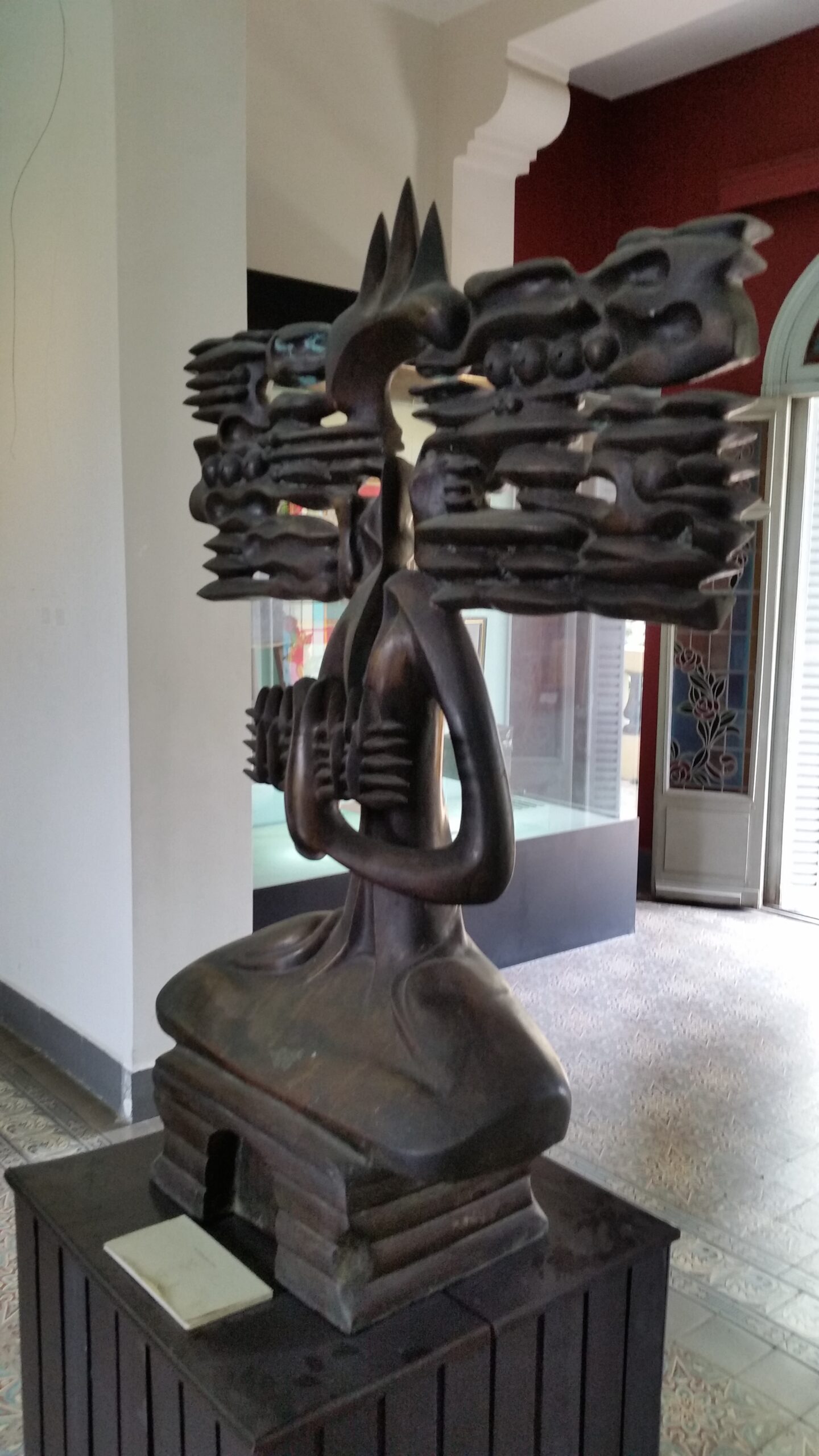 Abstract metal sculpture in a museum setting.