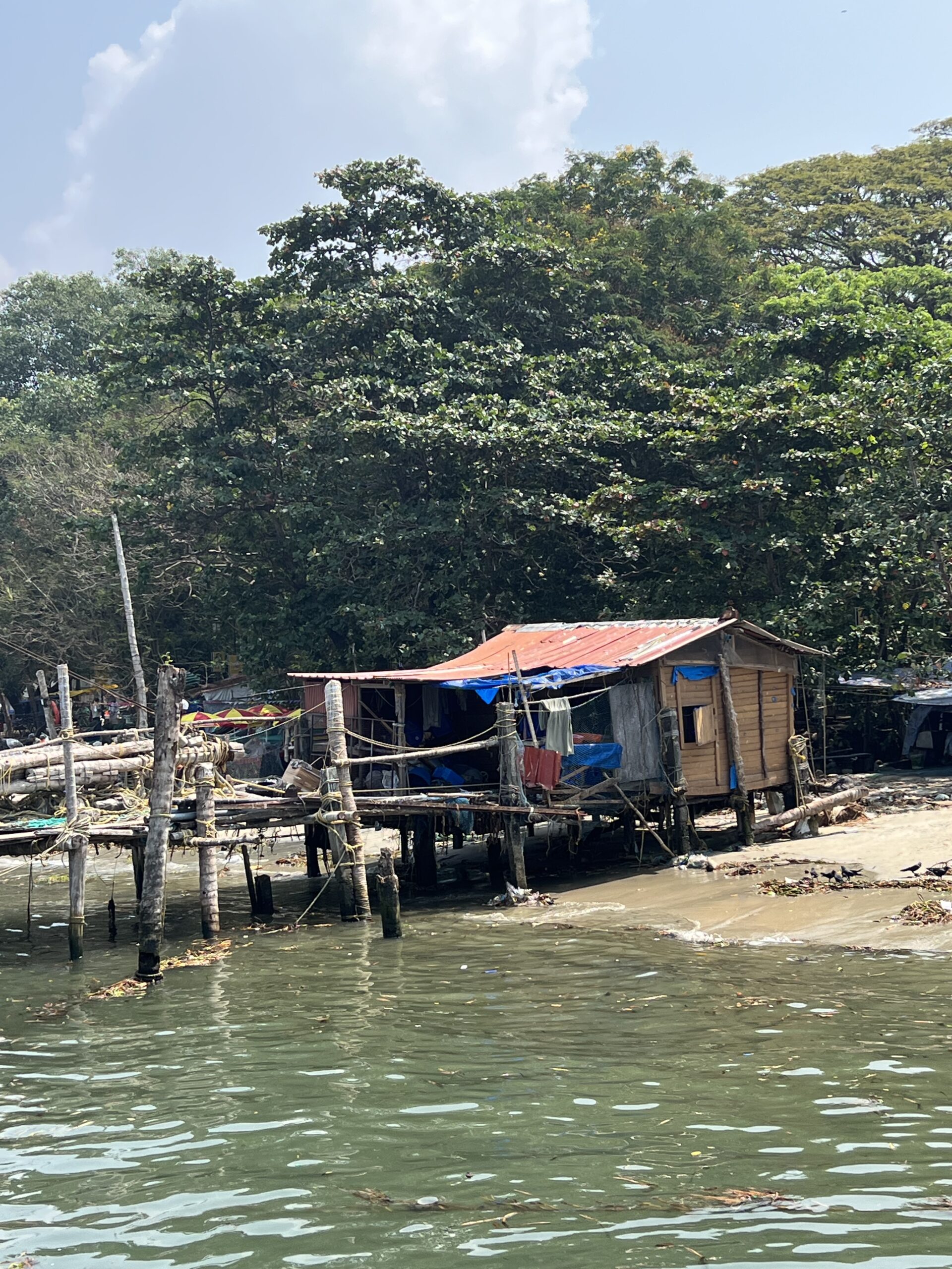 Wooden hut by the water's edge.